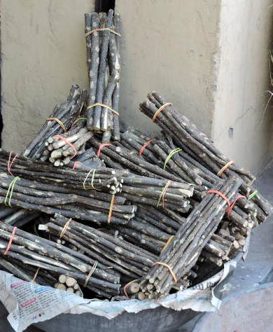 An image of a stack of bundled chewing sticks in India