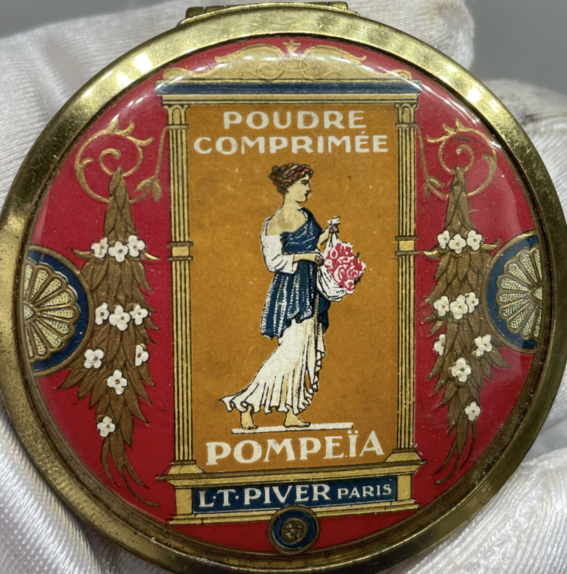 An image of an unopened container of nineteen twenty pressed powder makeup
